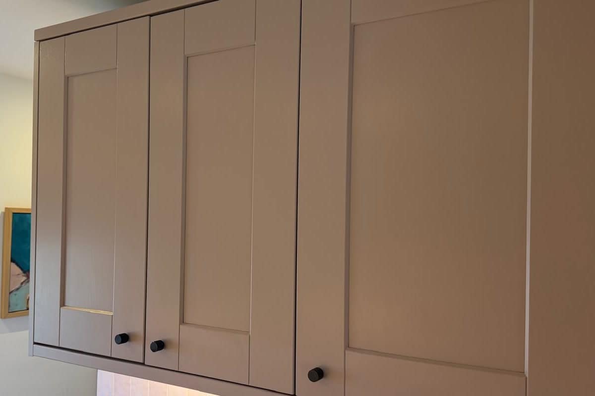 The same run of wall cabinets after respraying in taupe