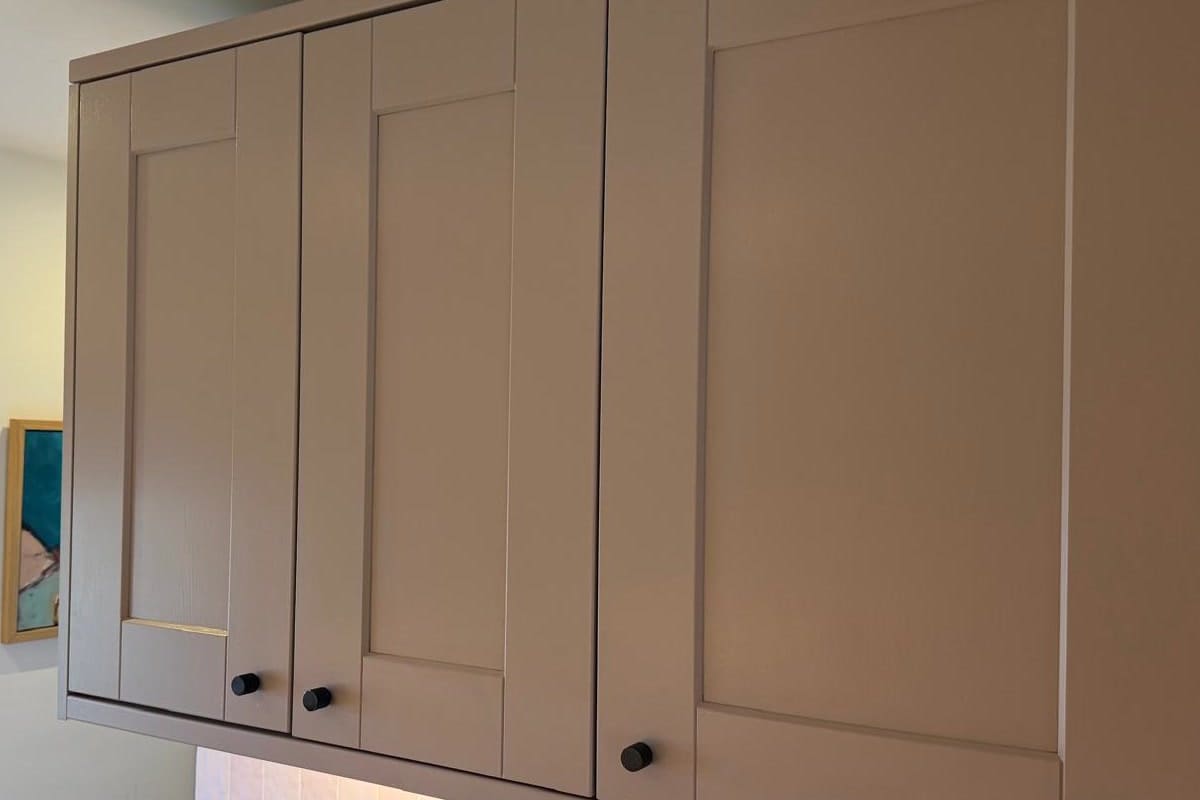 A run of wall cabinets after respraying in taupe