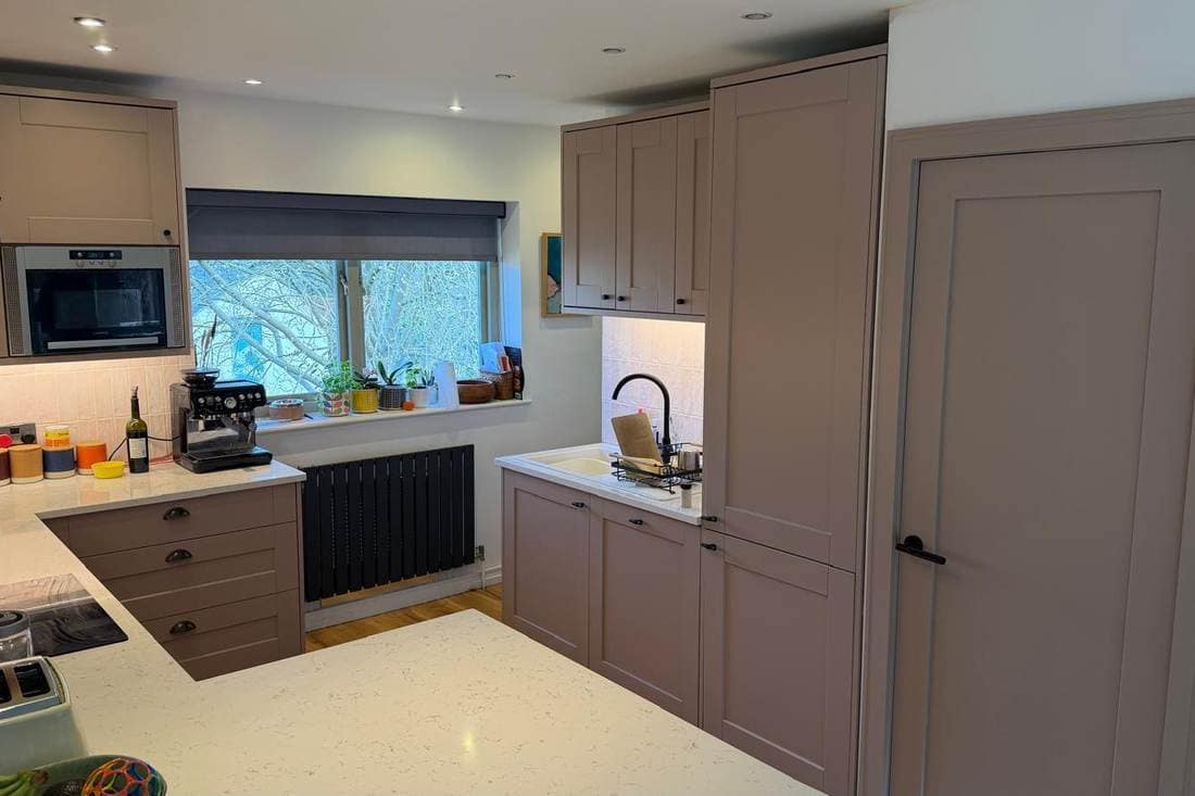 The same kitchen after respraying in taupe, with the white worktop unchanged