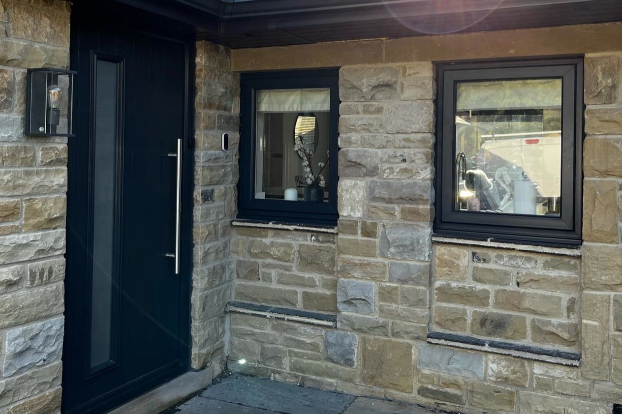 Porch window frames and door sprayed anthracite against stone