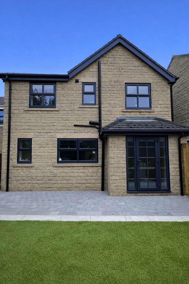 Every window frame on a house elevation after spraying in anthracite