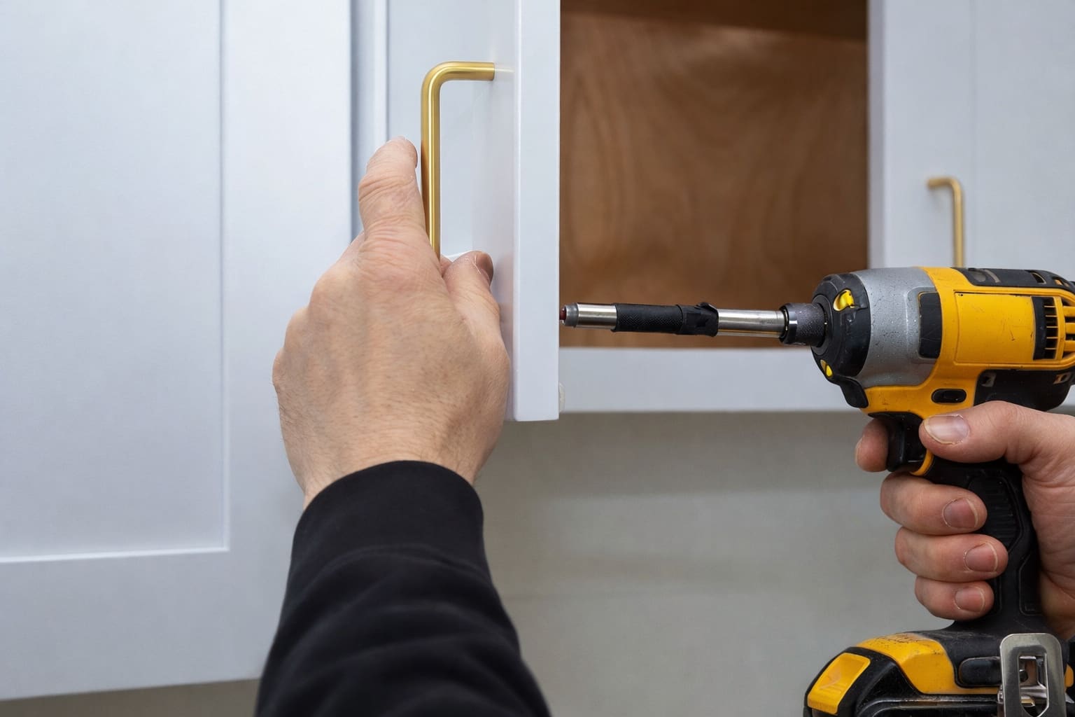 Fitting a new brass handle to a freshly sprayed kitchen door