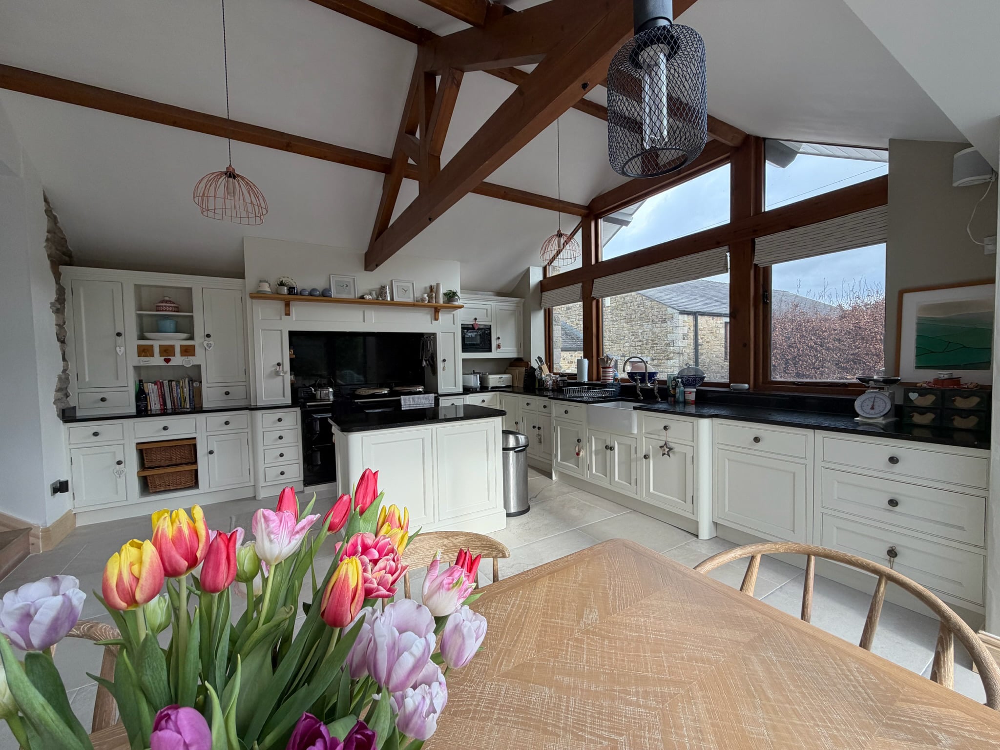 Bright white shaker kitchen after respraying, with a wooden worktop